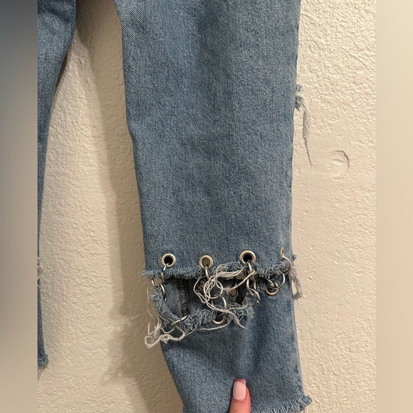 Jeans are cropped at the ankle and wide in the waist. - Picture 8 of 9